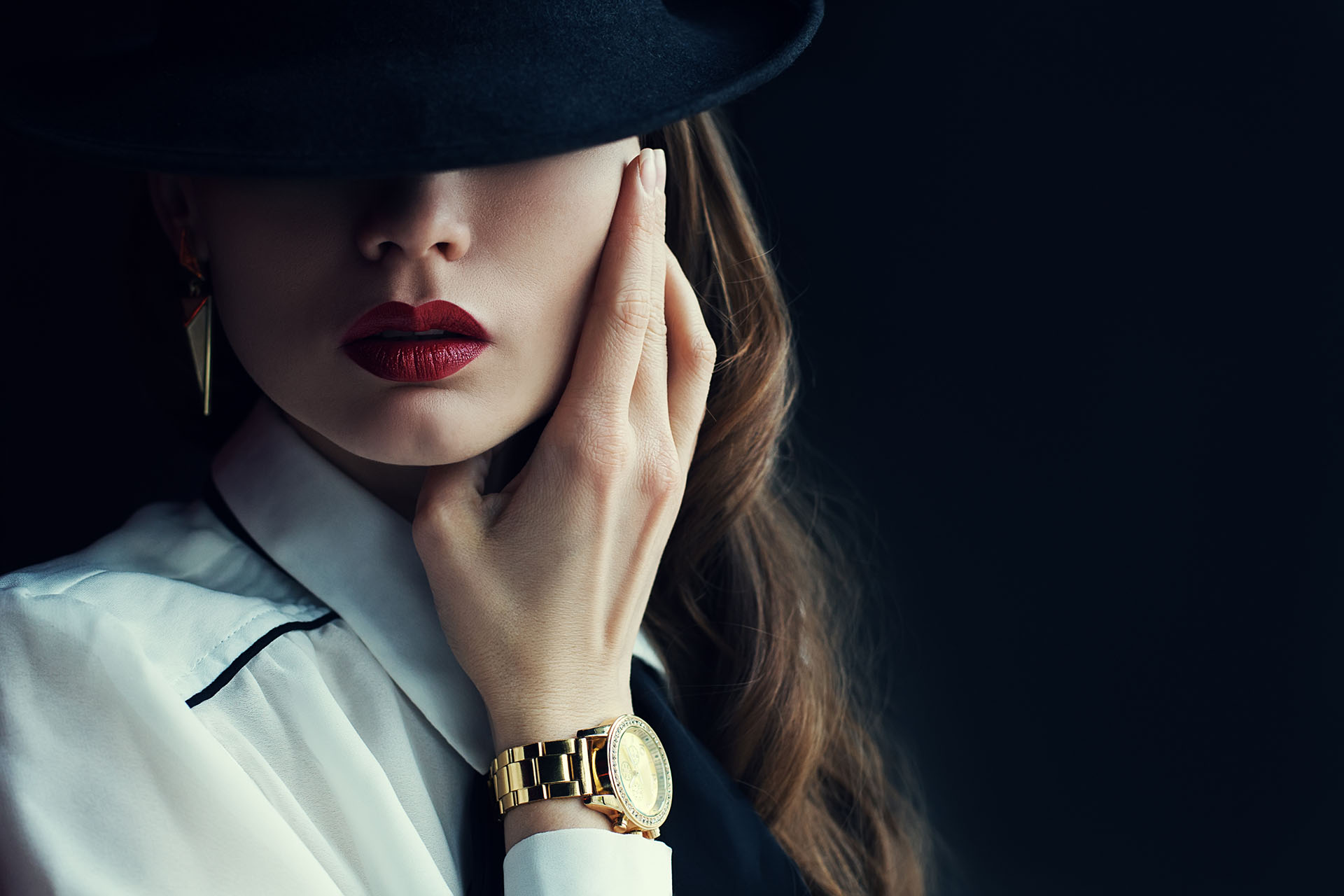 Indoor portrait of a young beautiful fashionable woman wearing stylish accessories