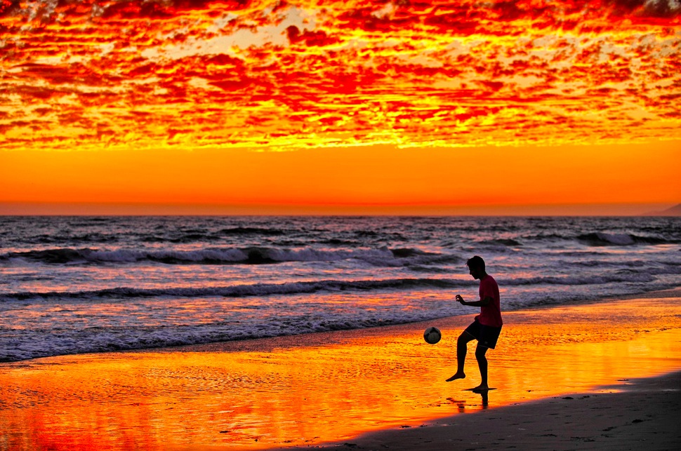 Man Kicks Soccerball at Sunset at Zuma Beach