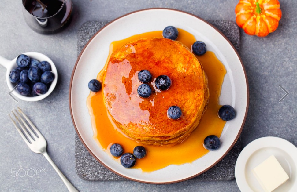 pumpkin-pancakes-with-maple-syrup-and-blueberries-on-a-plate