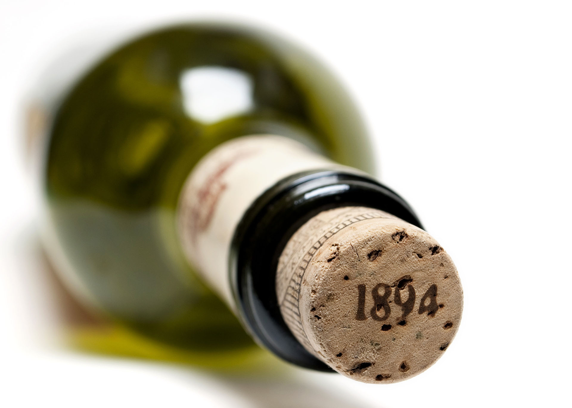 A bottle of green glass on a white background