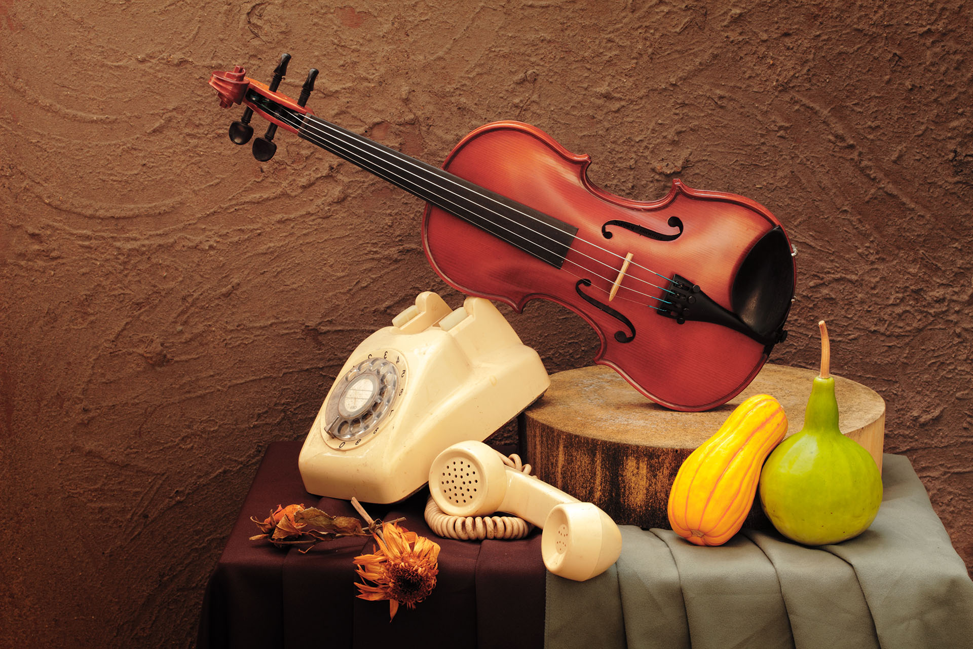 Still life art photography concept with violin and vintage telephone on grunge background