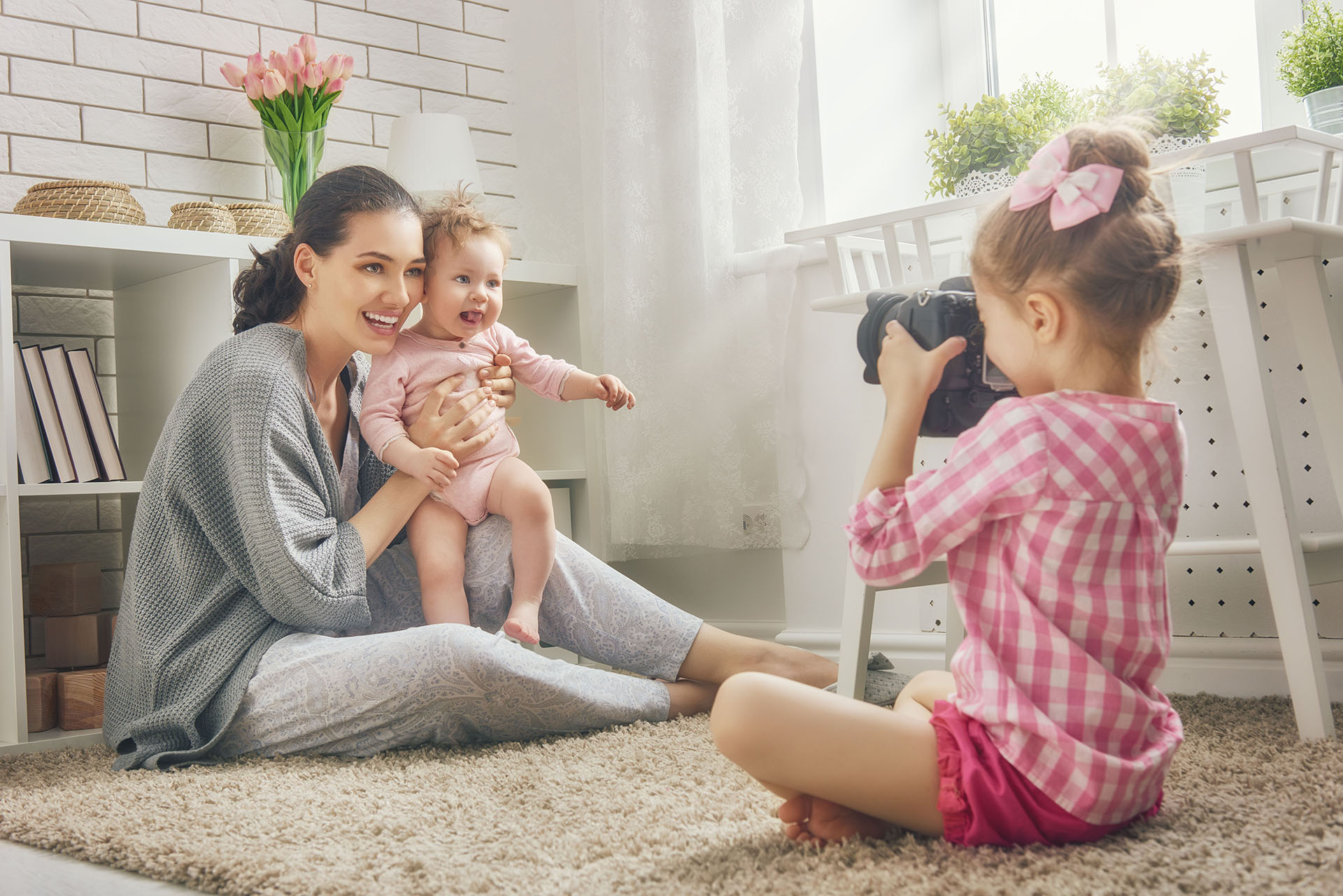 Mother and her daughters children girls playing and making photo