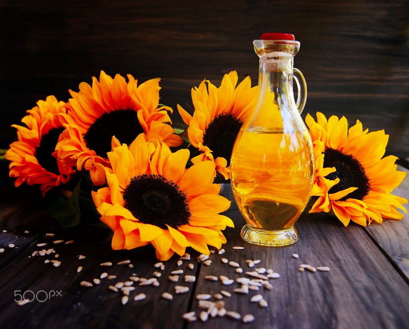 Sunflowers, sunflower seeds and a bottle of oil