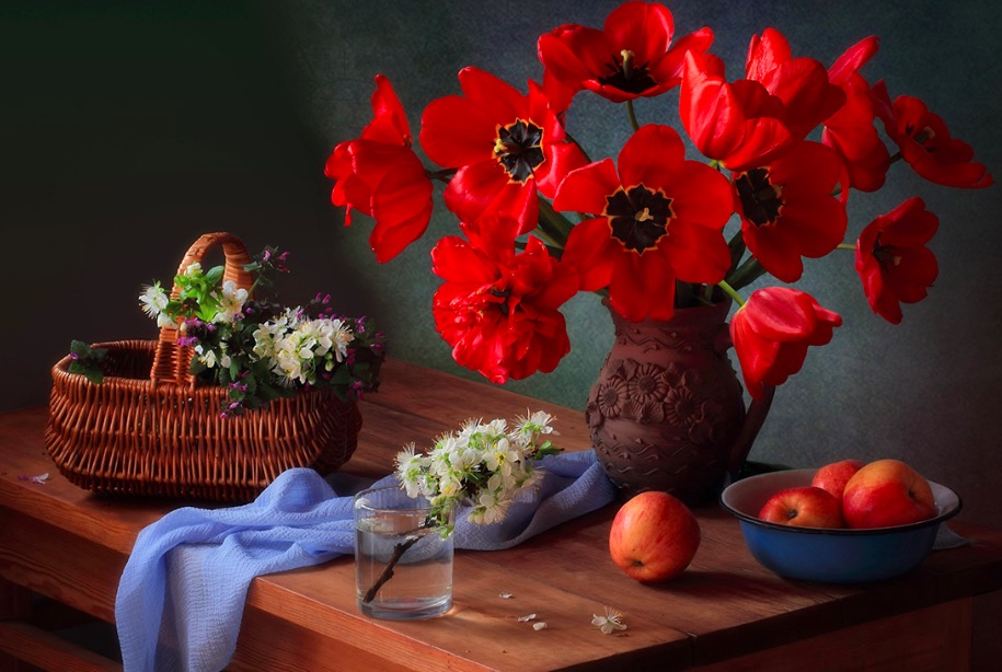 With a bouquet of red tulips