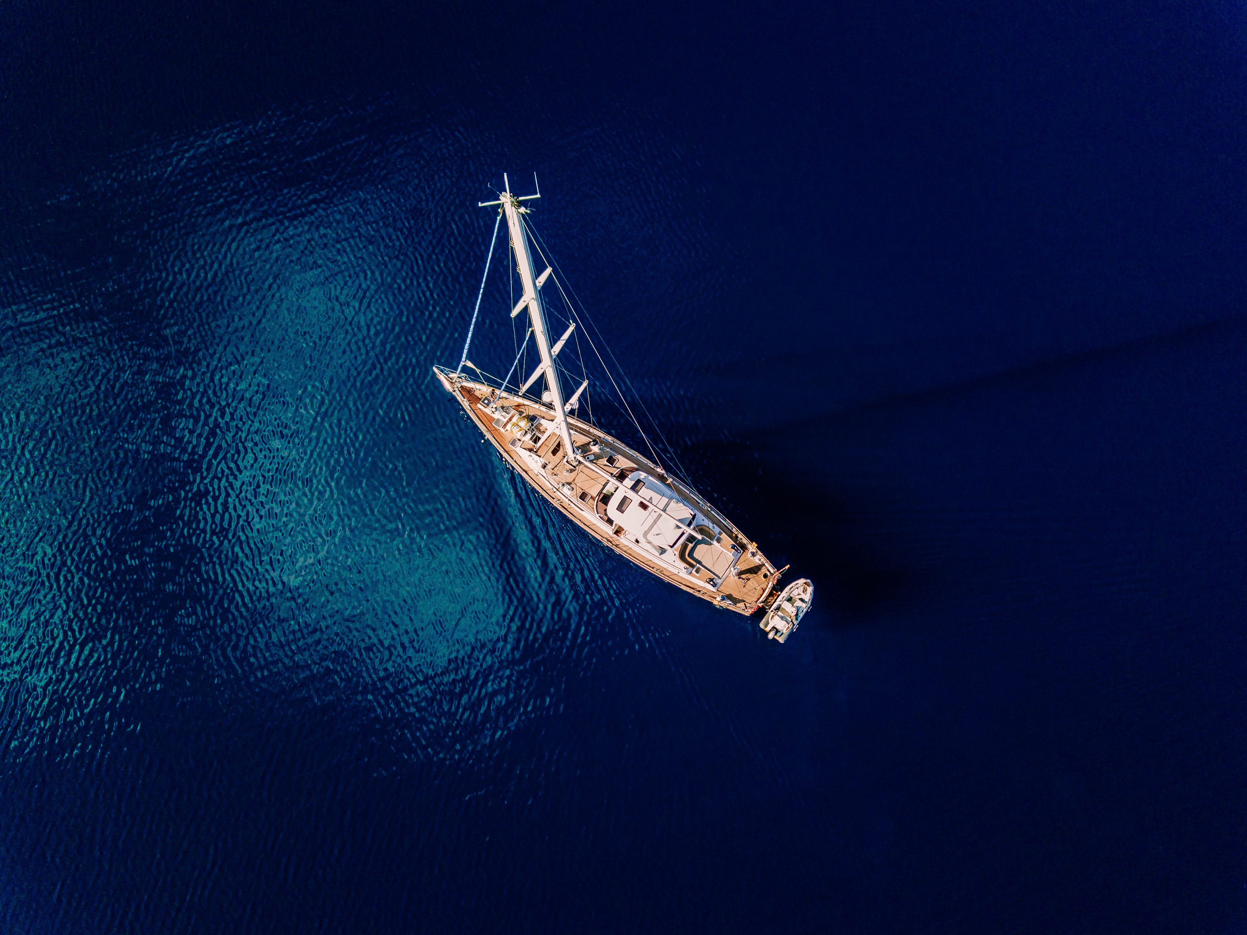 Aerial view to Yacht in deep blue sea