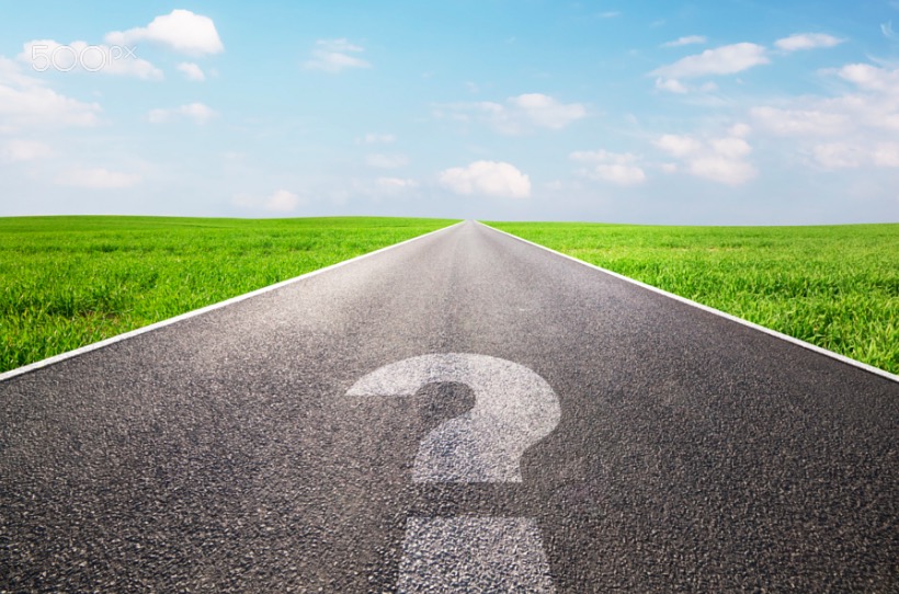 Question mark symbol on long empty road