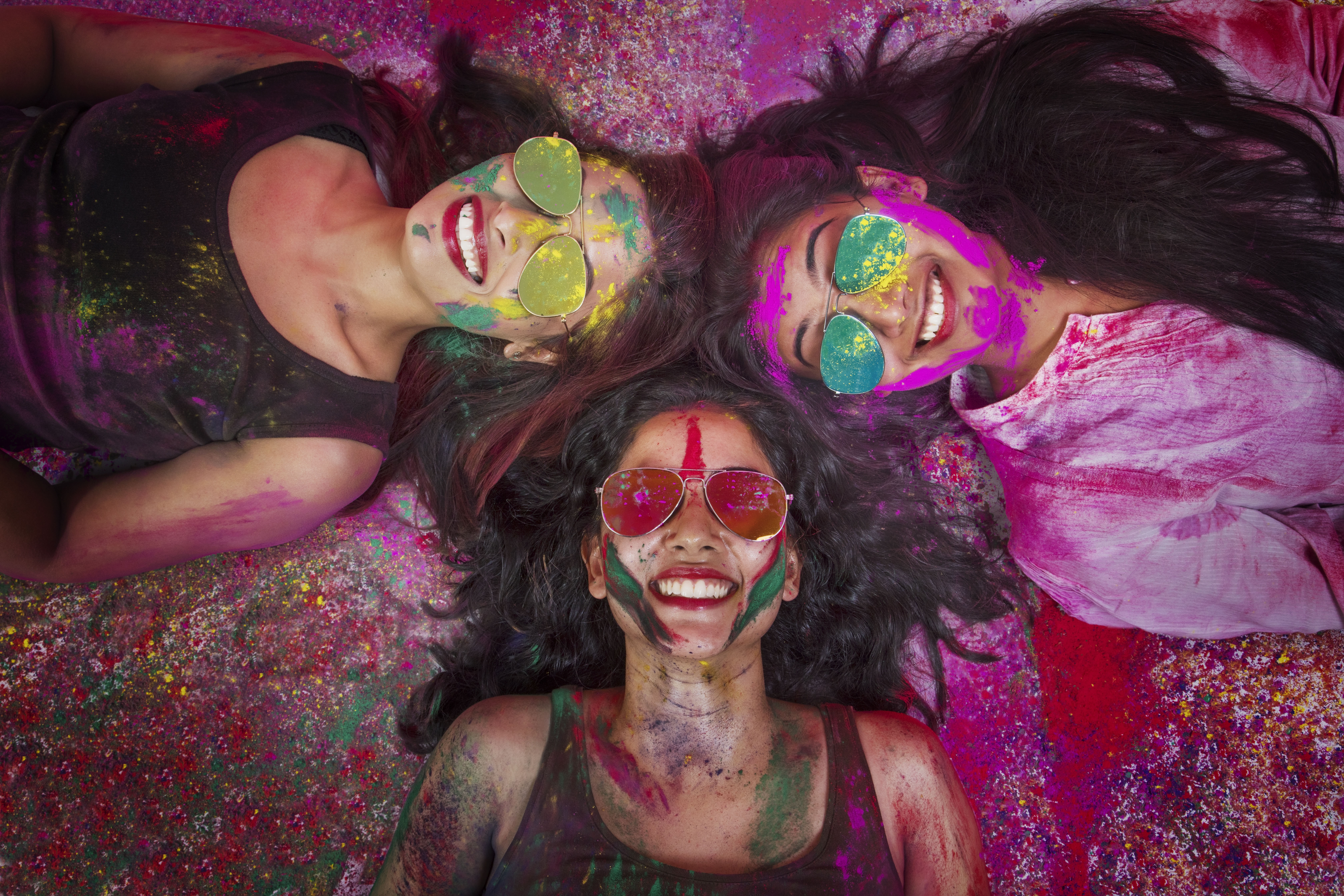 High angle view of girls covered in colored powder during holi color festival