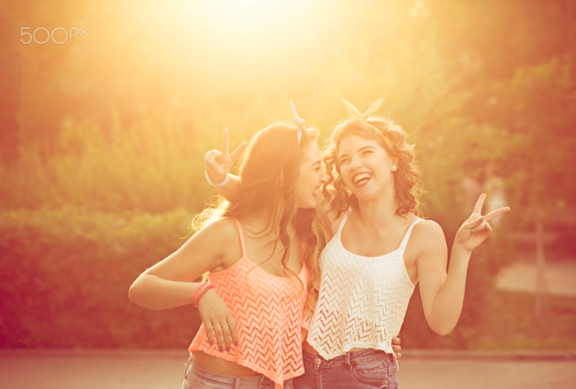 Best girlfriends hug. Sunset.