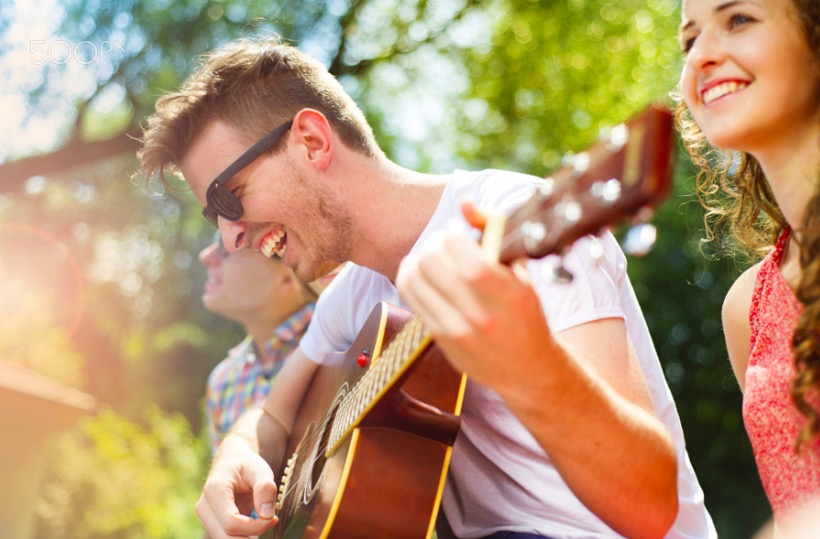 Friends having fun with guitar