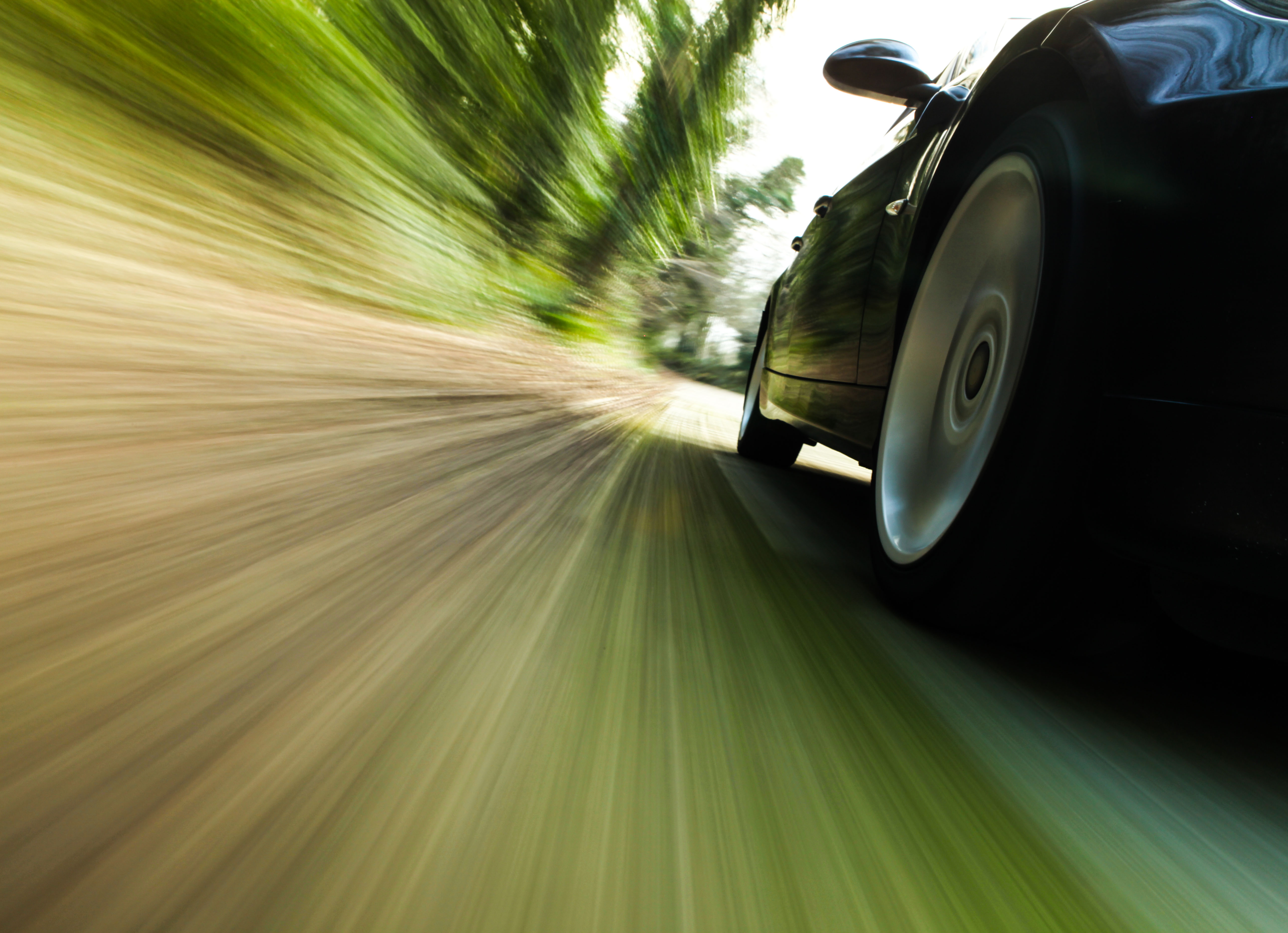Front side of black car driving fast