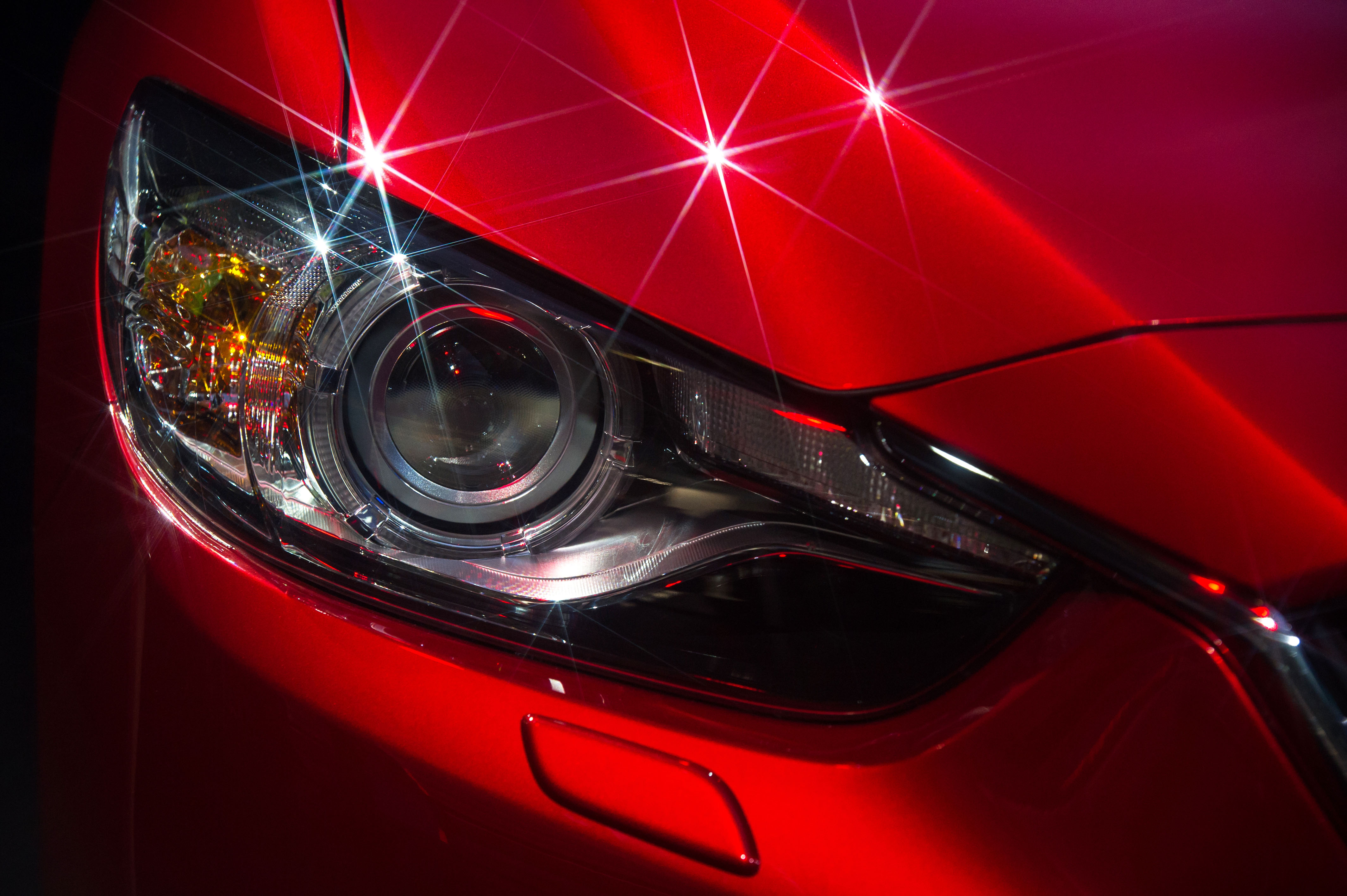 Headlight and hood of sport red car with Silver stars