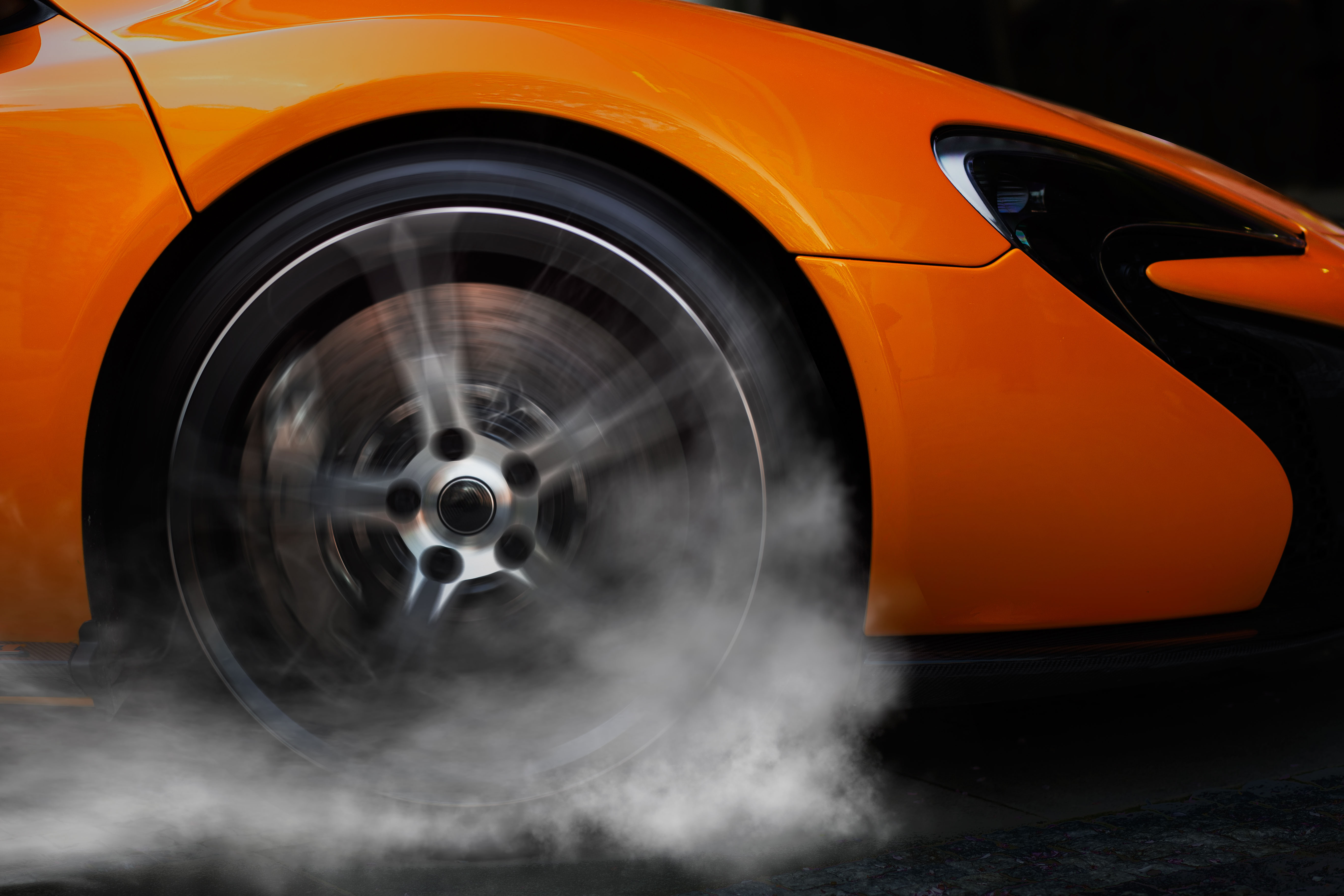 Orange Sport car with detail on drifting wheel