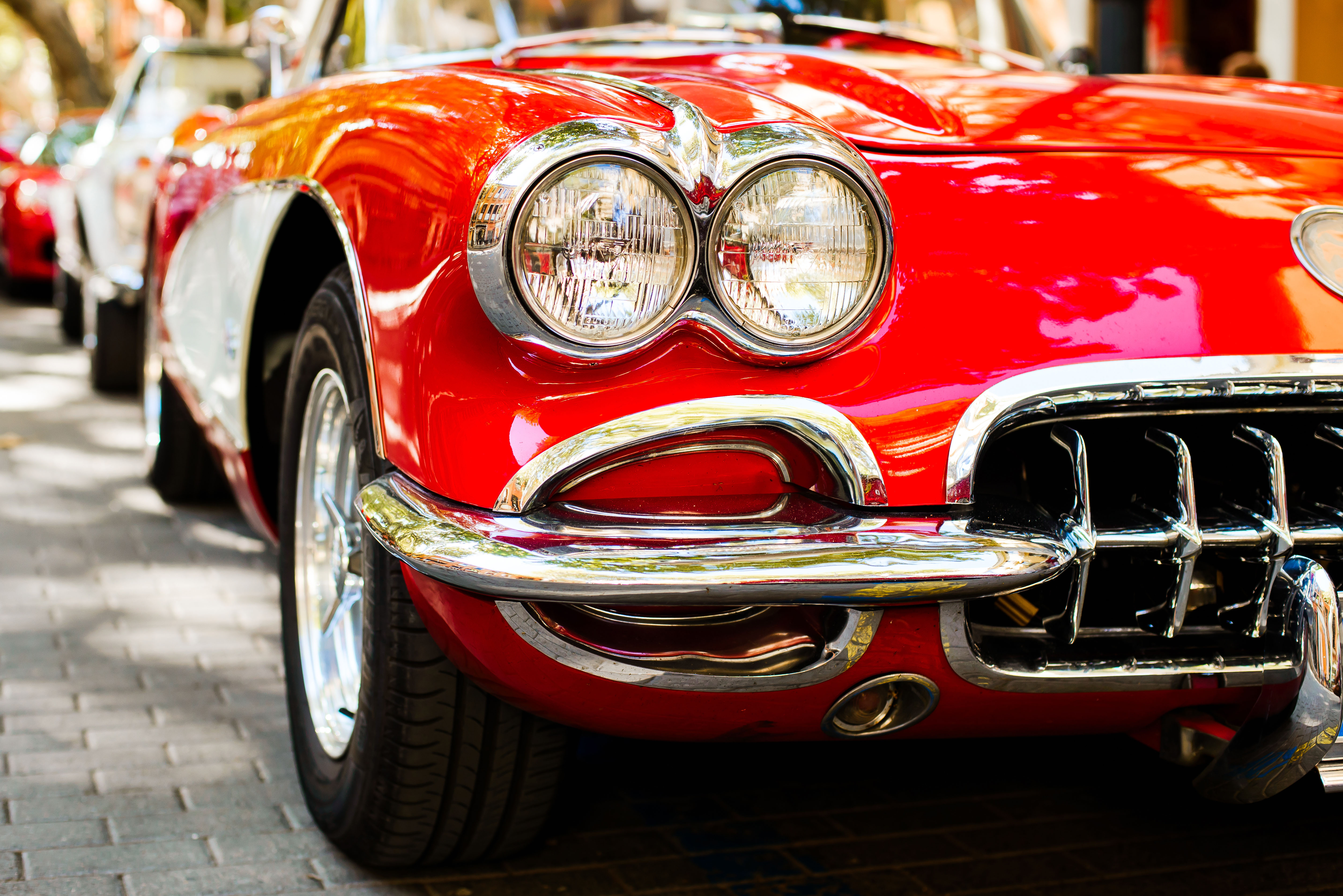 close up of headlight of red vintage car
