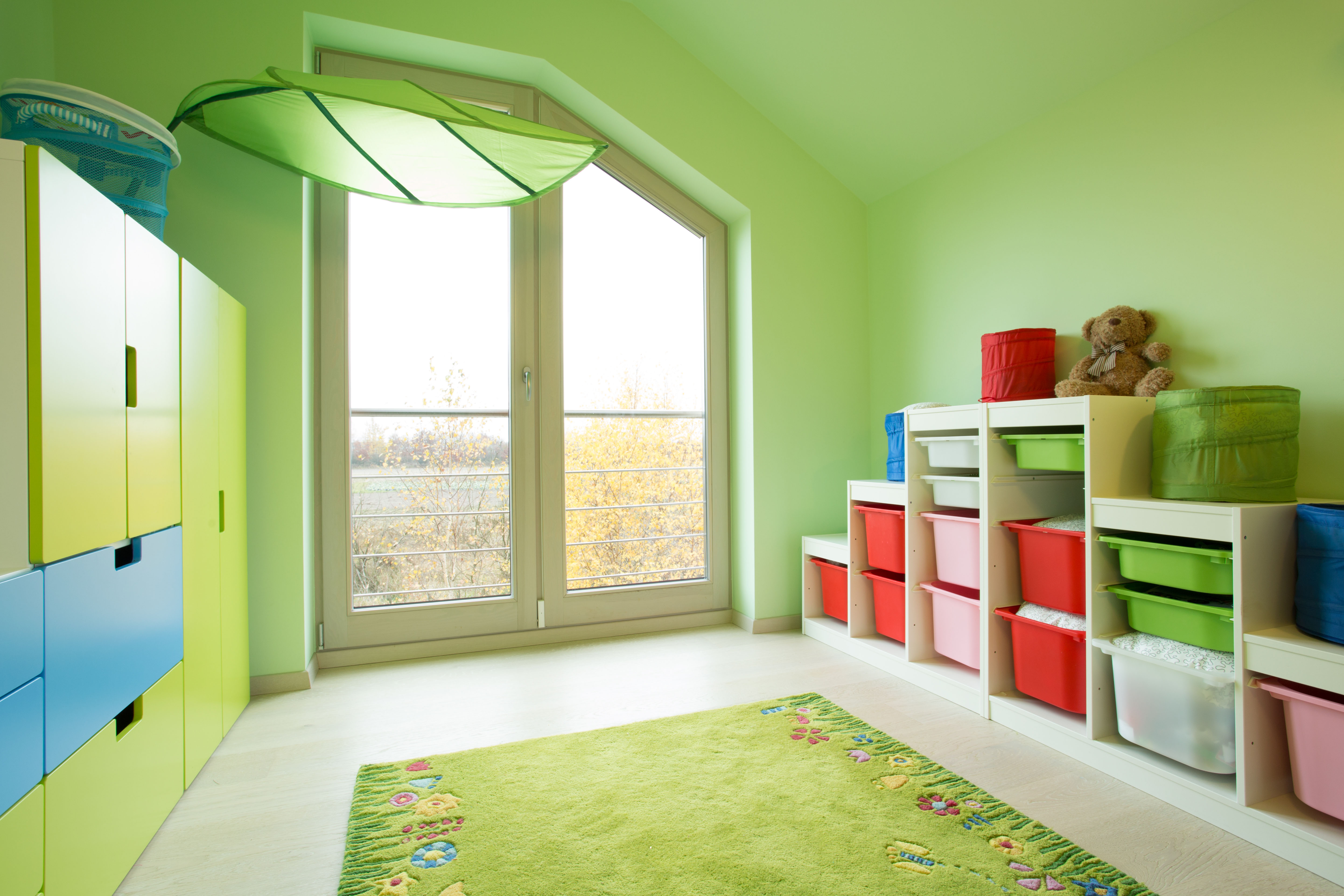 Cozy child's room with green painted walls