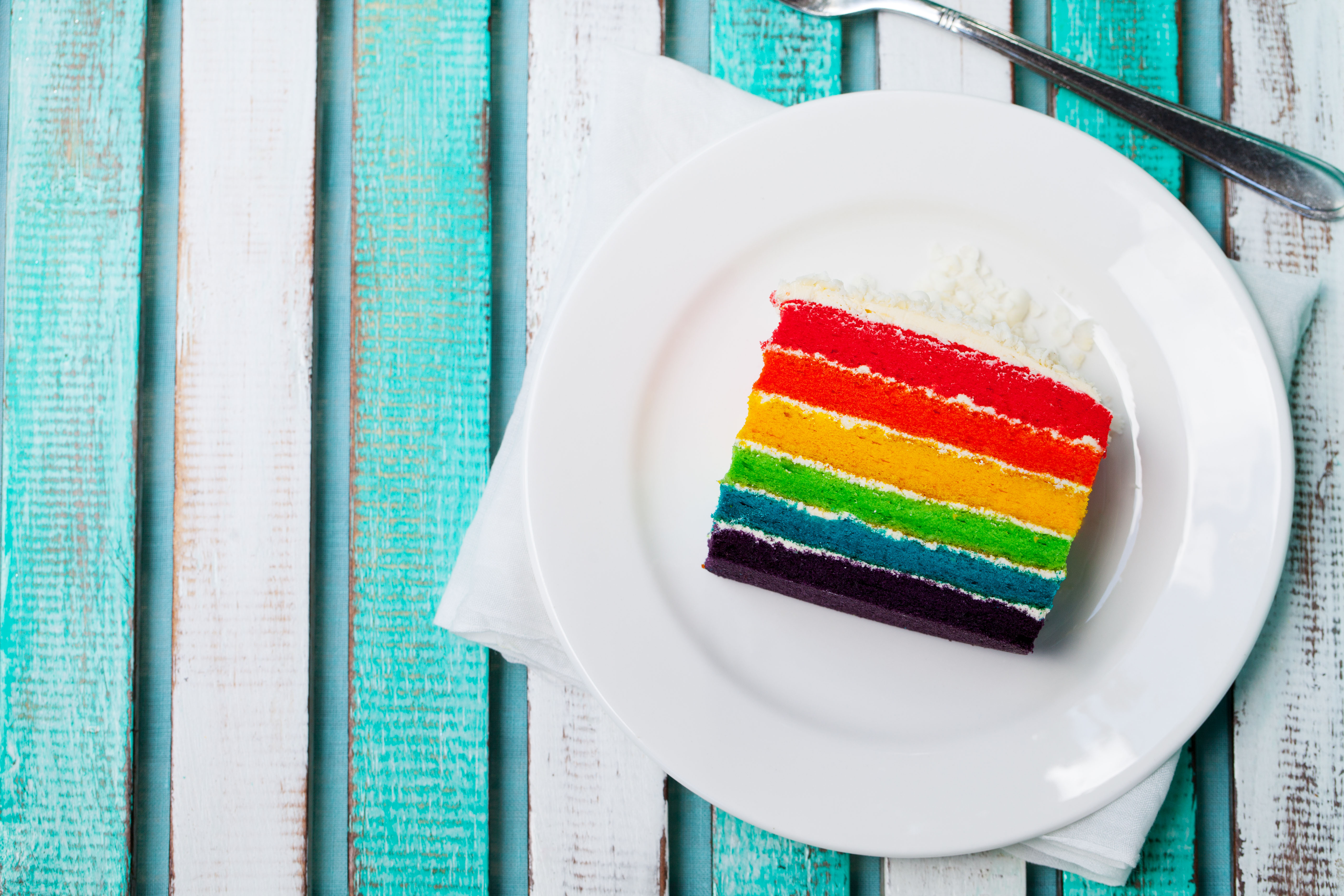 Rainbow cake on a white plate