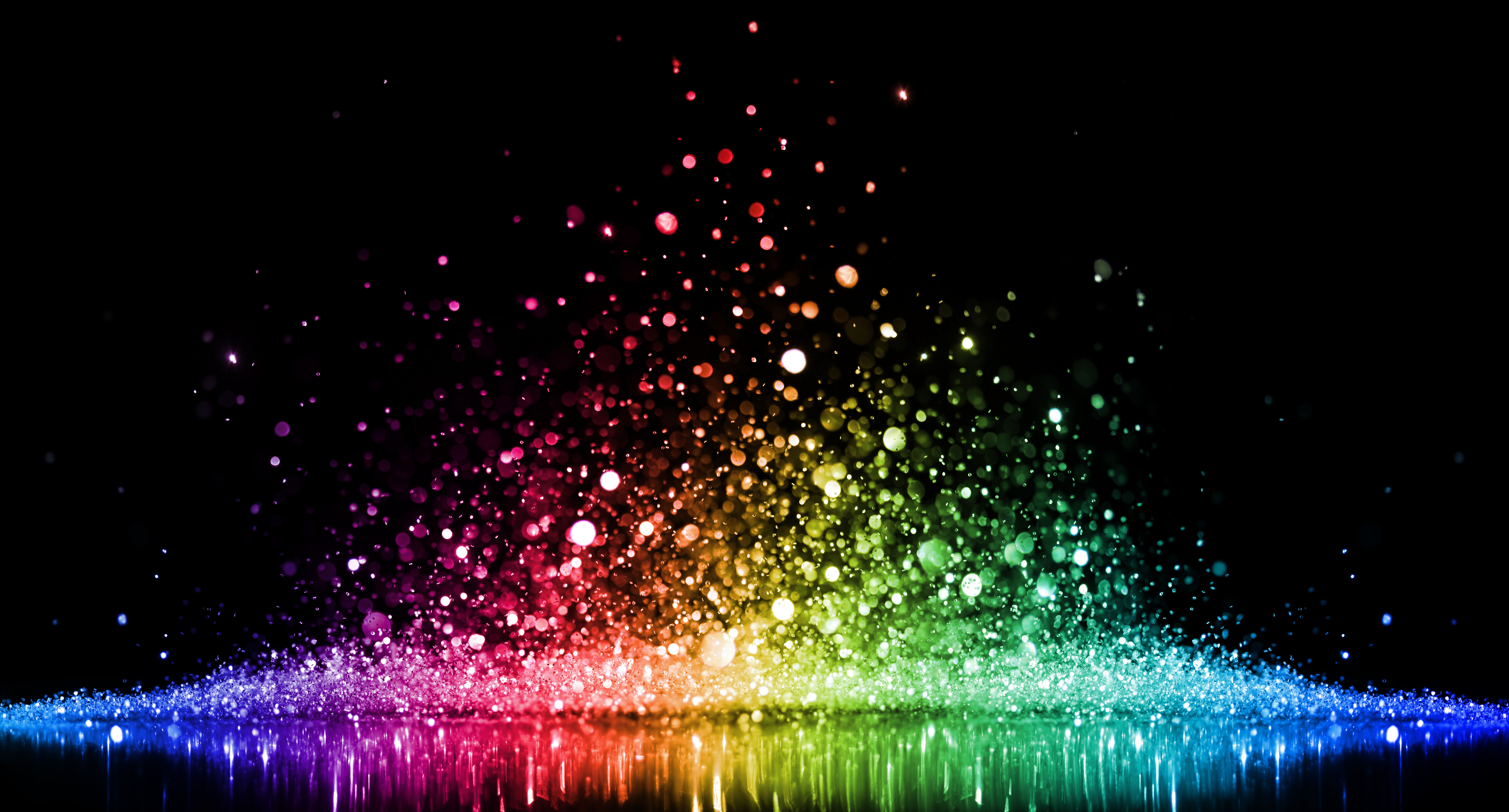 Rainbow of sparkling glittering lights abstract background