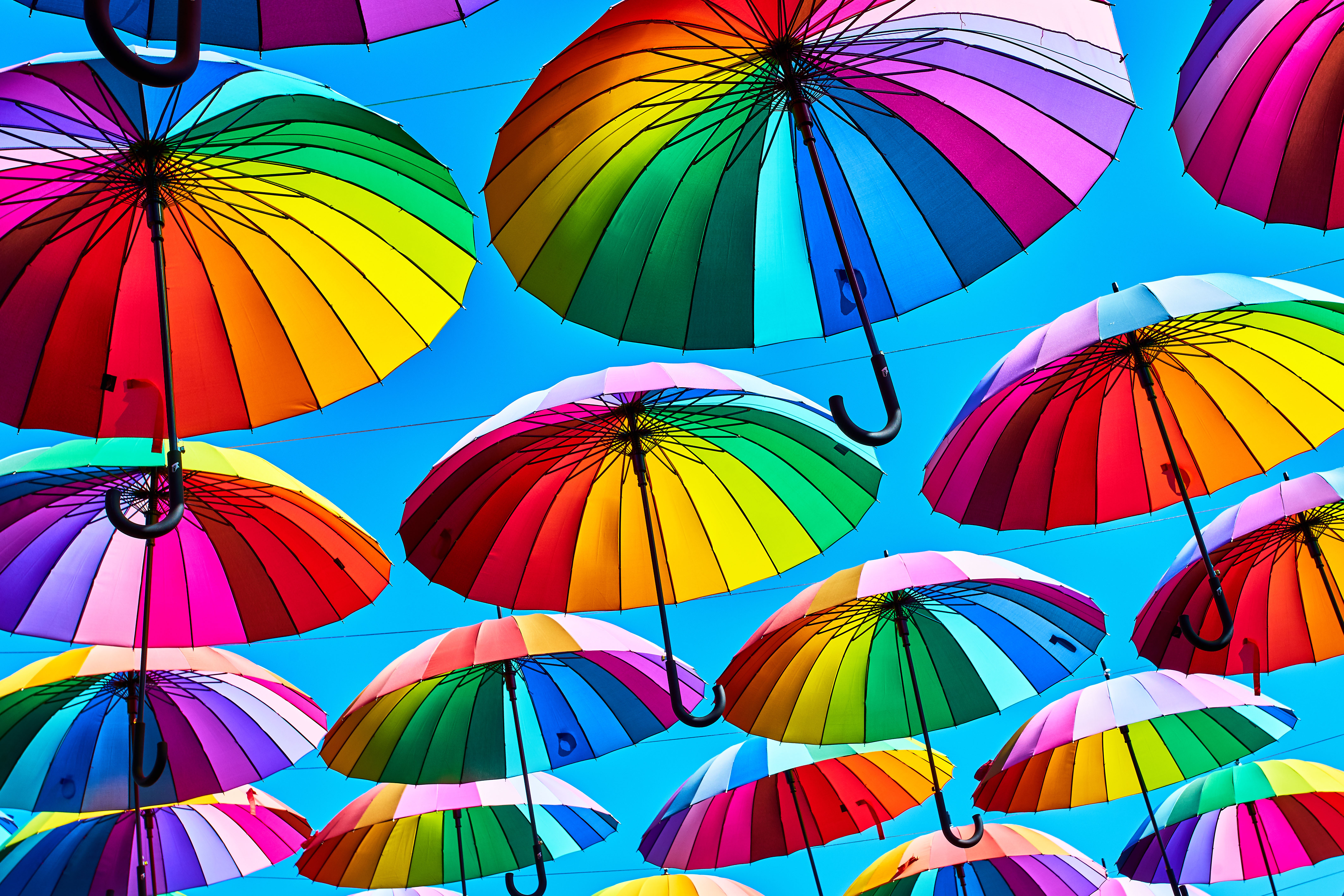 Rainbow umbrella on sky background
