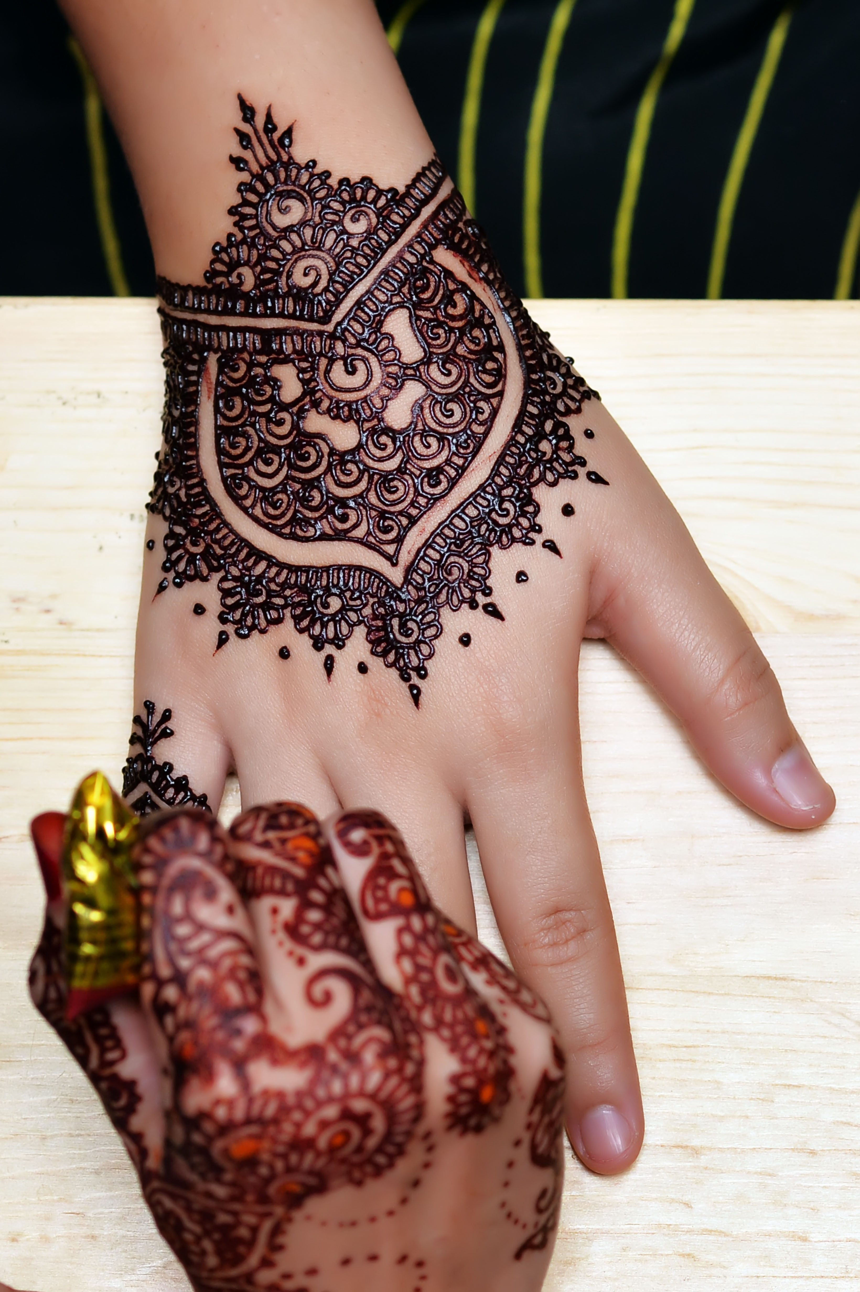 Artist applying henna tattoo