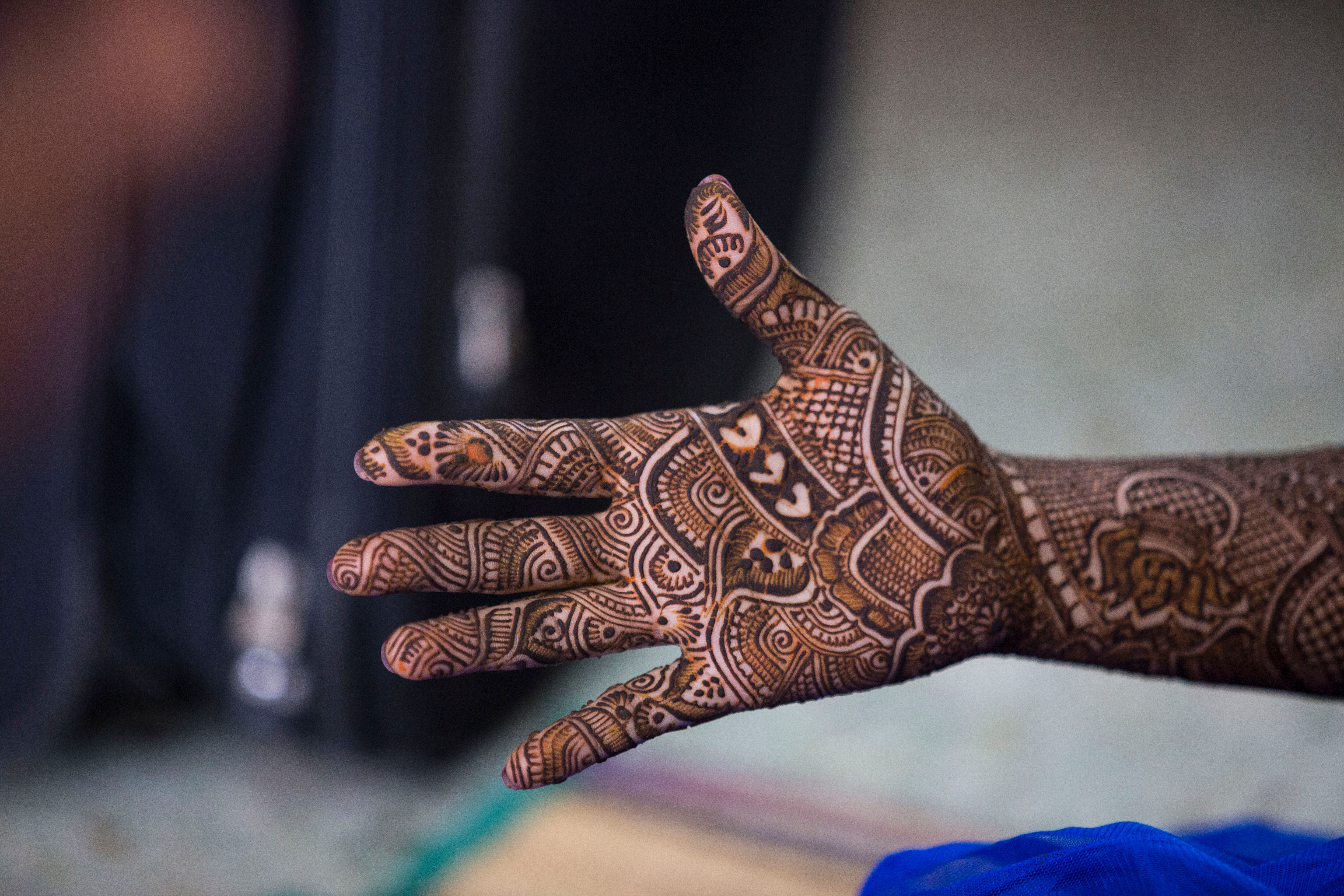 Indian bride showing mehendi, henna hands