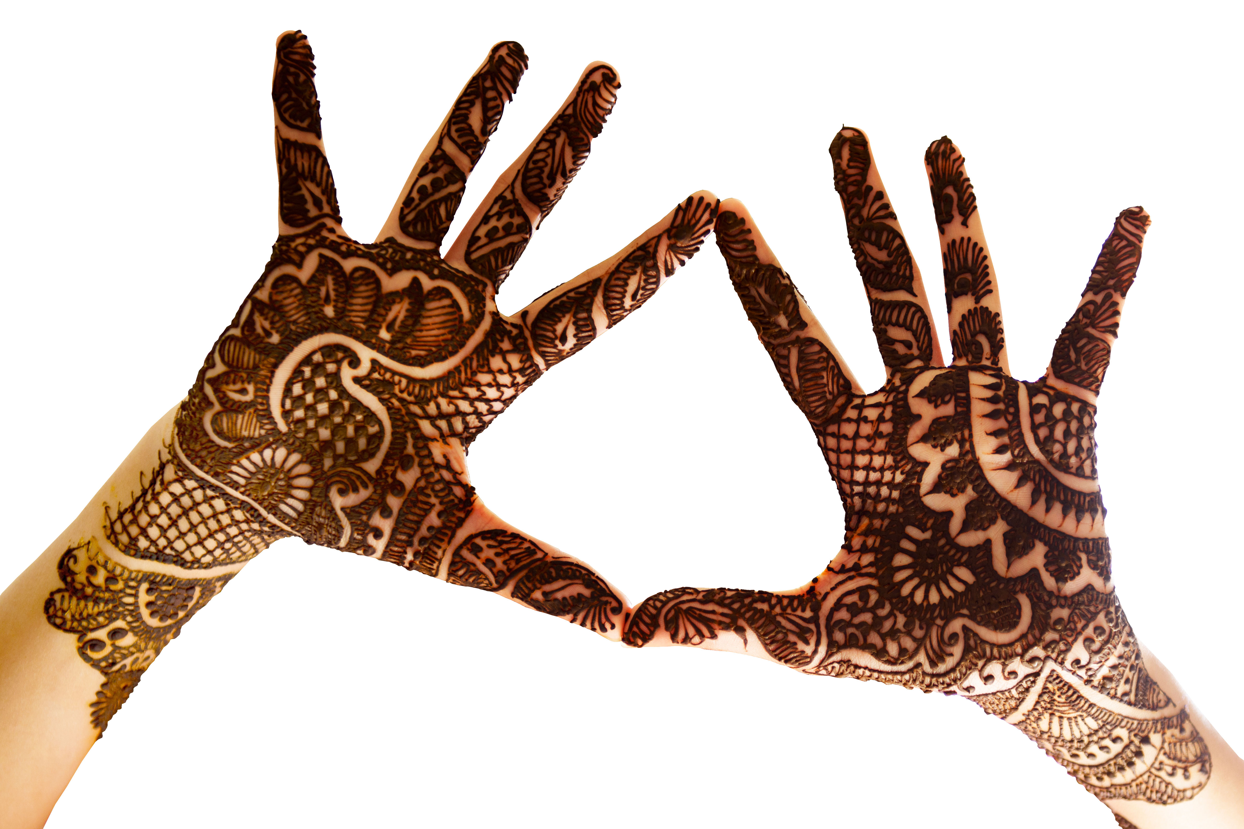 The hands together to show the beautiful Henna tattoo at the open hands