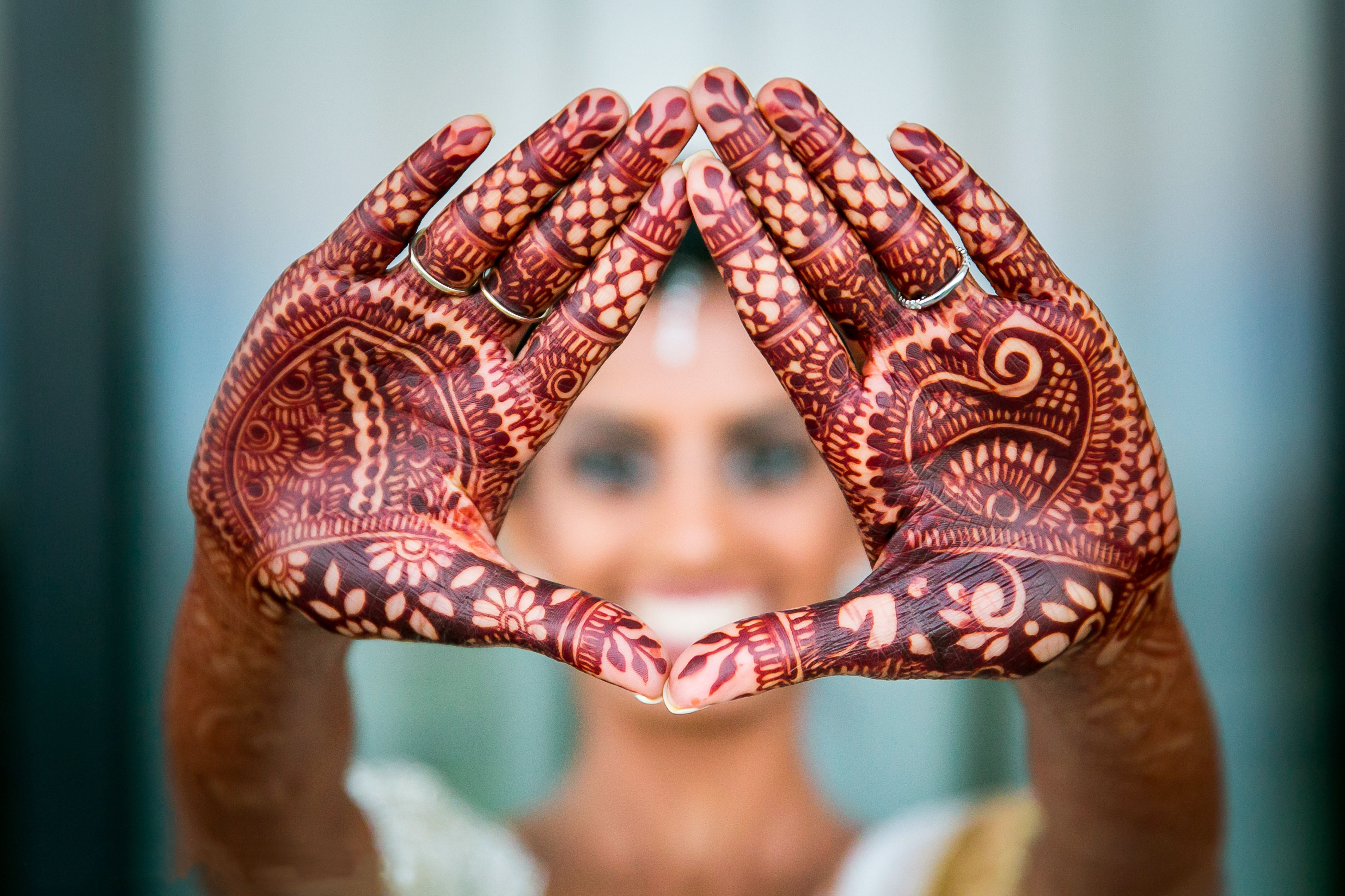 Wedding bride showing hand make heart mehndi art