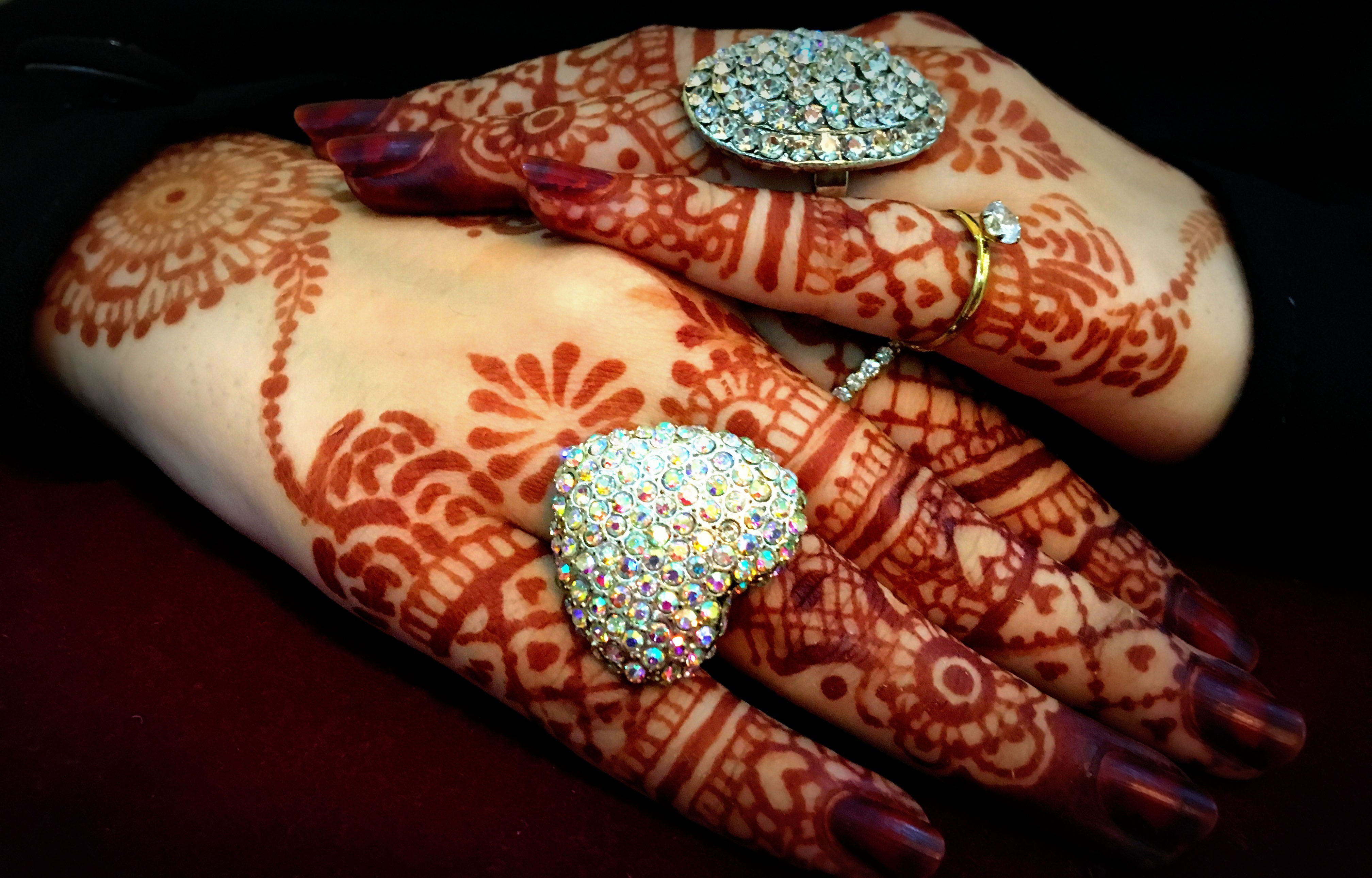 bride hands with henna and ring