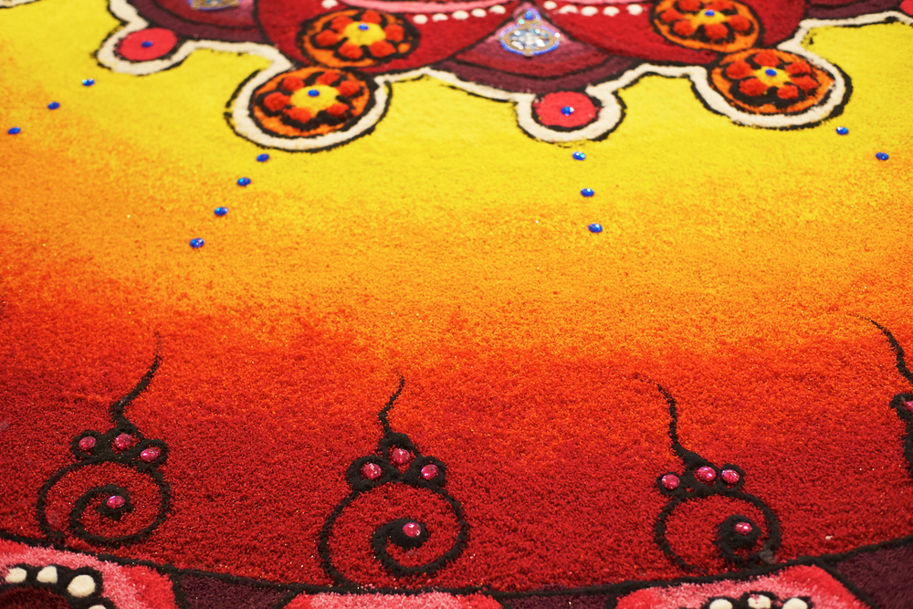 Deepak with colourful rangoli 1