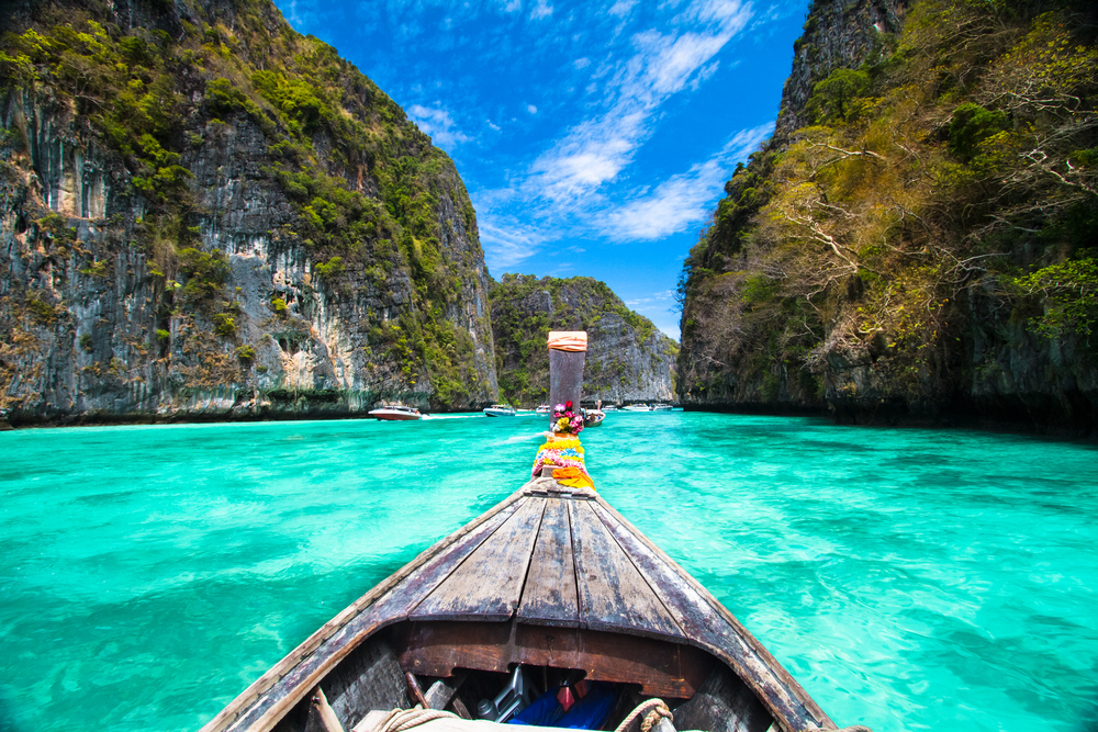 Traditional wooden boat in a picture perfect tropical bay on Koh Phi Phi Island