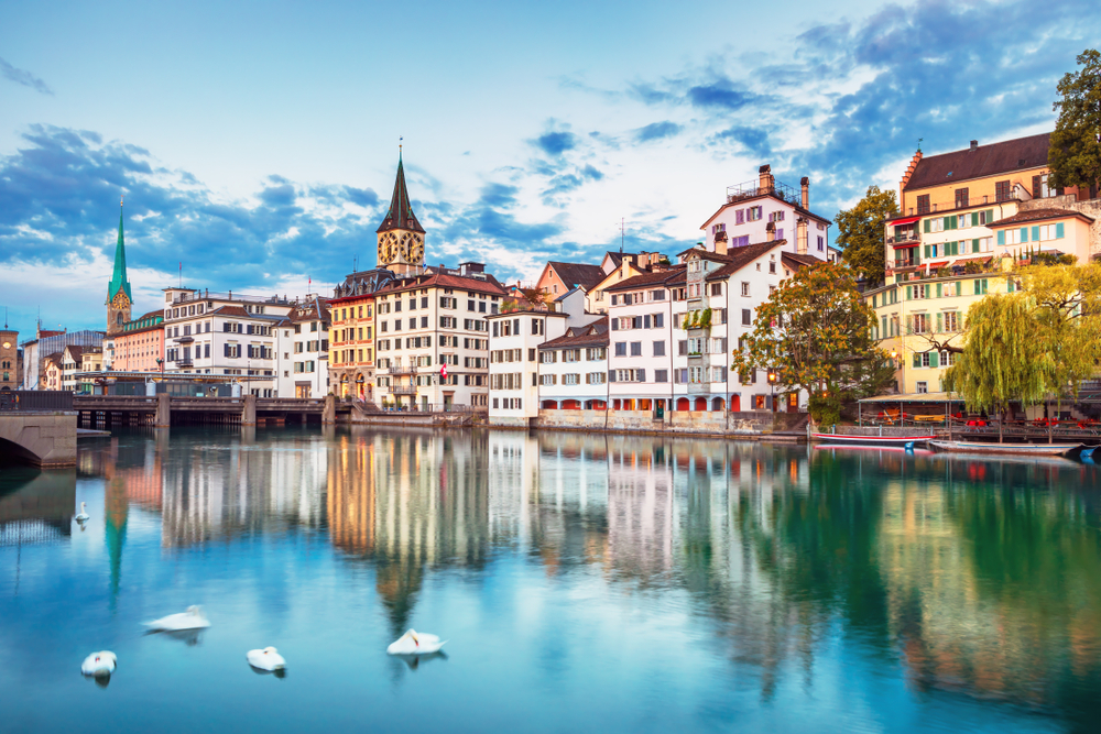 Scenic view of historic Zurich city centre with famous Fraumunster and Grossmunster Churches and river Limmat at Lake Zurich