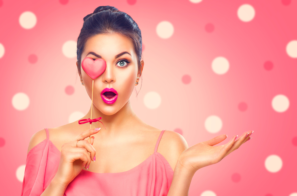 Girl with Valentine Heart shaped cookie in hand