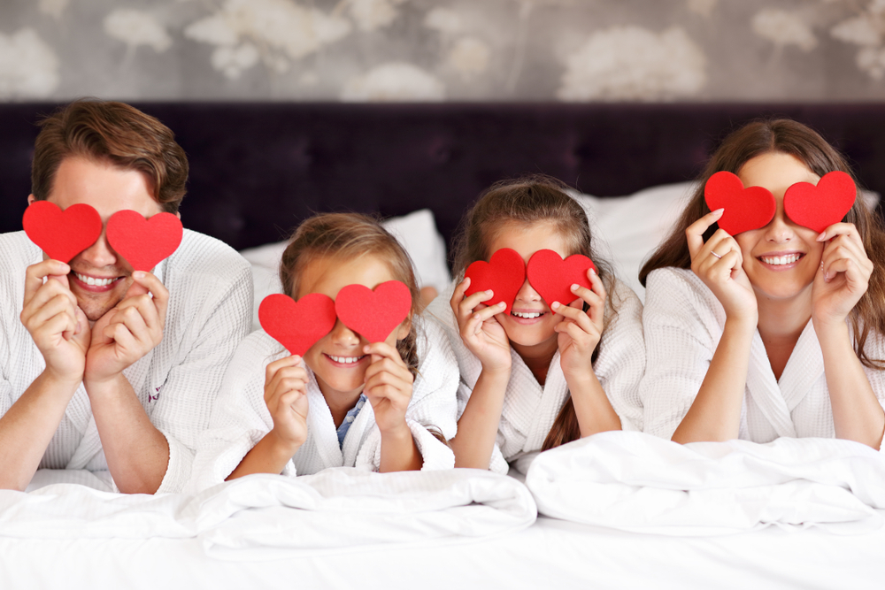 Happy family relaxing in hotel room