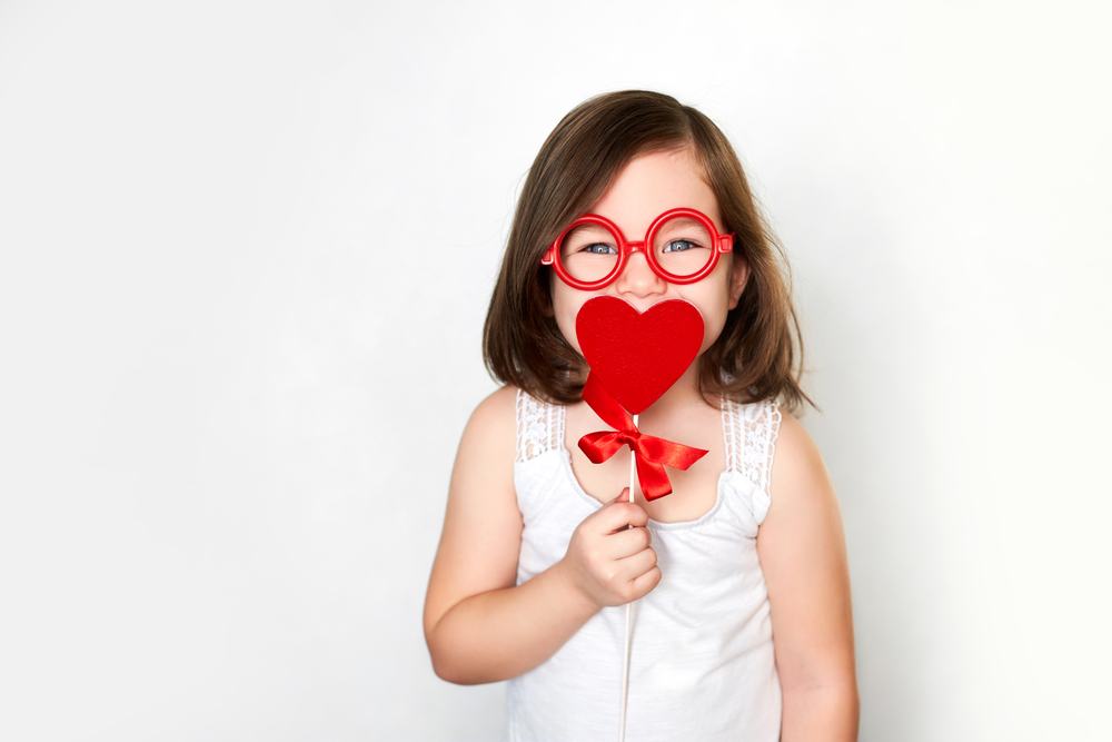 Smiling little child in toy glasses