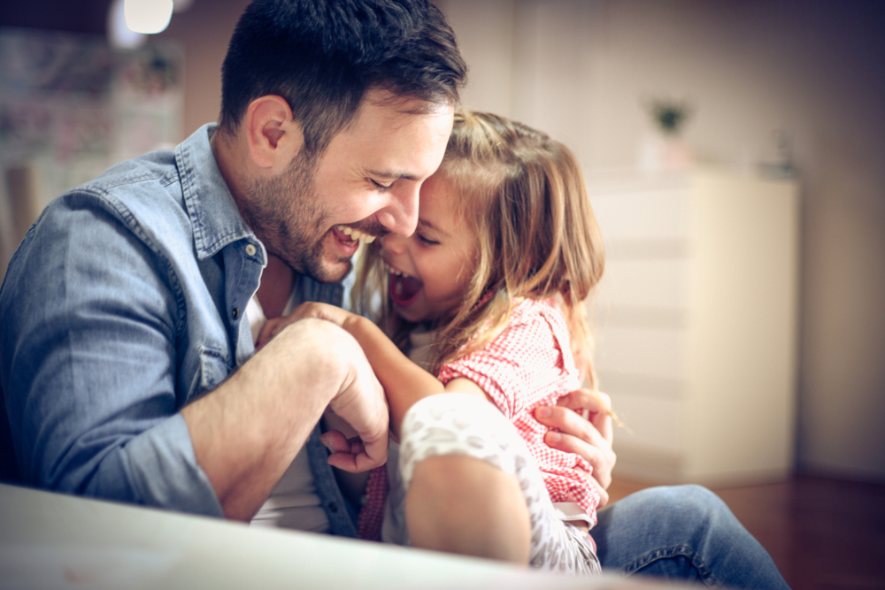 Father and daughter playing together at home