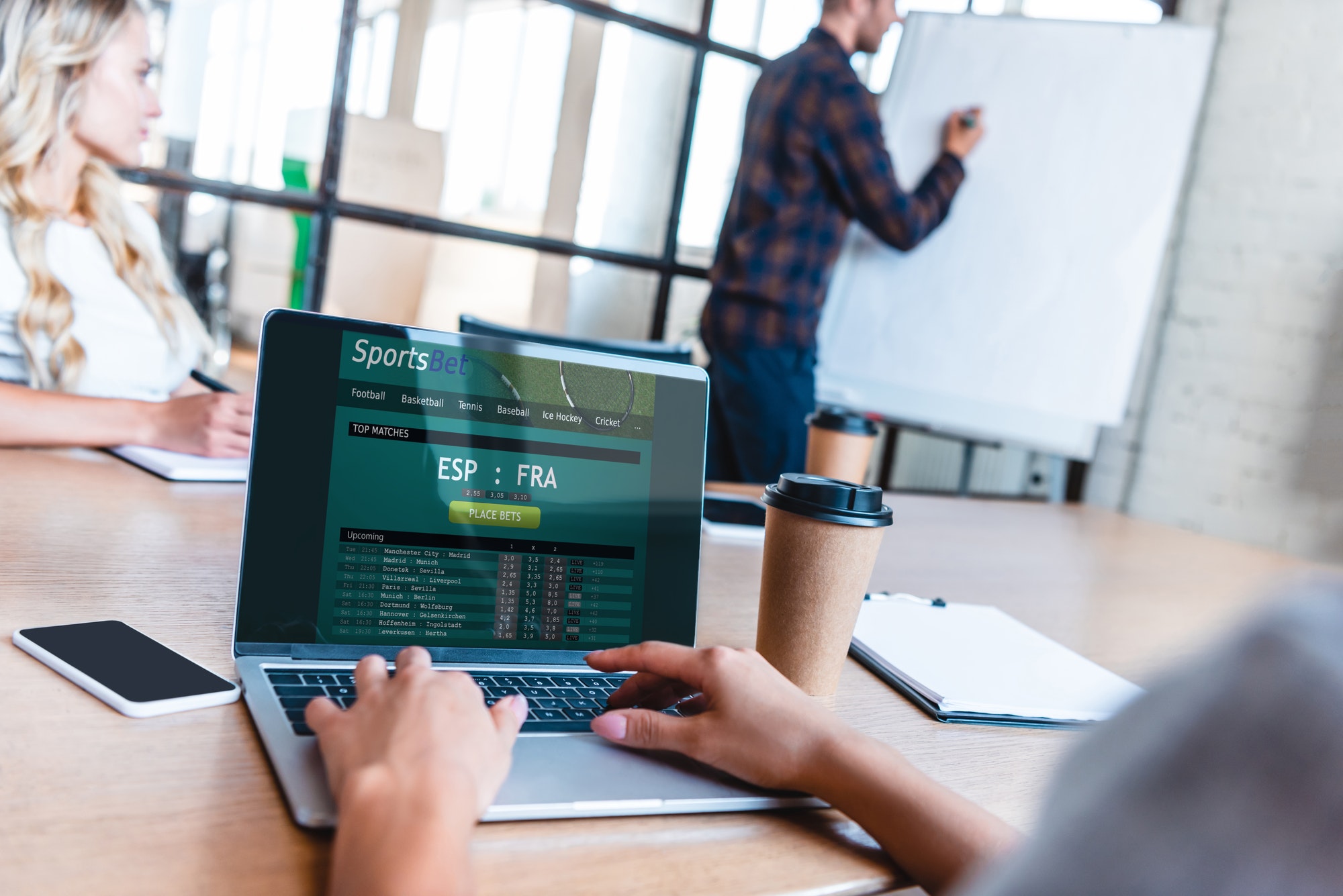 cropped cropped shot of business person using laptop with sports betting app on screen during
